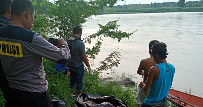 Petugas bersiap mengevakuasi jasad Swan Sindi yang telah dibawa ke tepi sungai oleh warga