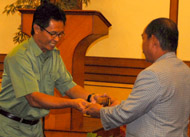 Asisten III Setkab Kukar Sutrisno menyerahkan palu sidang kepada Munadi Arif sebagai pimpinan sidang sementara