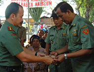 Letkol Inf Dwi Lestiyono (kiri) menyerahkan secara simbolis bantuan bagi korban kebakaran kepada Camat Tenggarong HM Gufron yang kemudian diteruskan kepada Lurah Melayu Rustam Effendi SSos (tengah)
