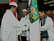 Asisten IV HM Ghufron Yusuf menyerahkan pataka lambang daerah Kukar kepada Amirul Haj Kukar