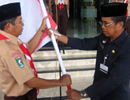 Pimpinan kontingen Pramuka Kukar H Asmara Diharja saat menerima bendera dari Kepala Dikluspora Ifni Juraidi