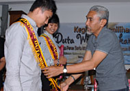 Kepala Disbudpar Kukar Azmidi memasangkan selempang kepada perwakilan finalis Duta Wisata Kukar 2010