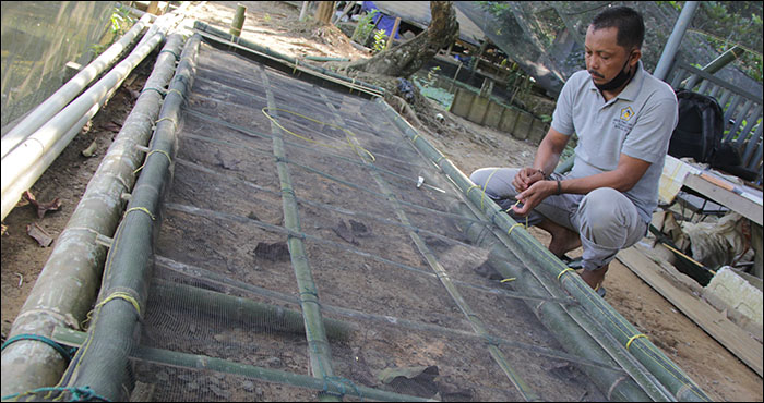 Petani asal Kelurahan Panji, Tenggarong, Ustuhri, saat membuat rakit untuk padi apung yang akan dikembangkan di kolam ikannya 