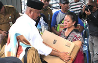 Bupati Edi Damansyah menyerahkan bantuan peralatan masak kepada salah satu korban kebakaran