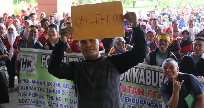 Salah seorang pengunjukrasa menunjukkan tulisan OM THL OM sebagai permintaan kepada pejabat daerah untuk memperhatikan nasib mereka