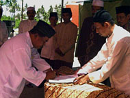 HM Tayyib (kiri) menandatangani naskah berita acara peresmian Masjid Ar-Razaq